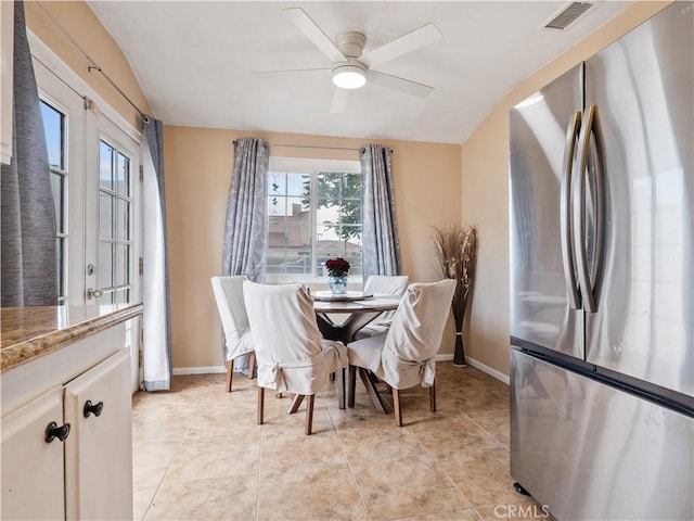 dining room with baseboards, visible vents, light tile patterned floors, and ceiling fan
