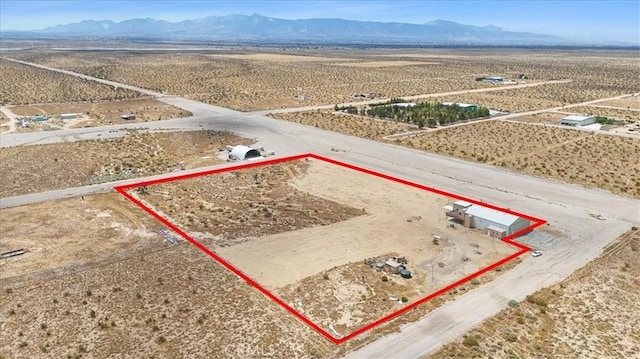 drone / aerial view with a rural view, a mountain view, and a desert view