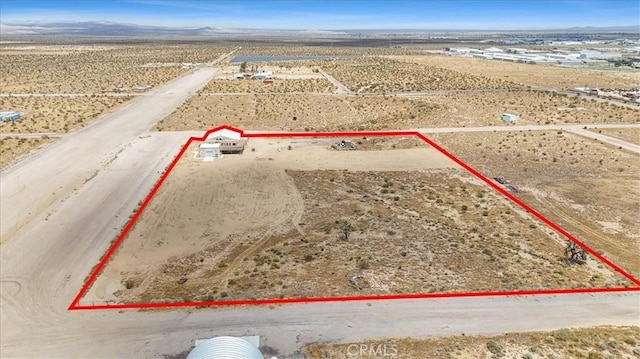 aerial view with a rural view, a mountain view, and a desert view