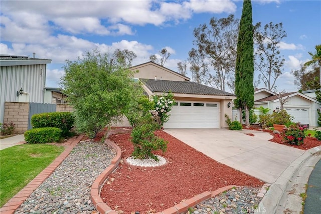 21751 Eveningside Ln, Lake Forest, CA 92630 - view of front of home featuring driveway, an attached garage, and stucco siding