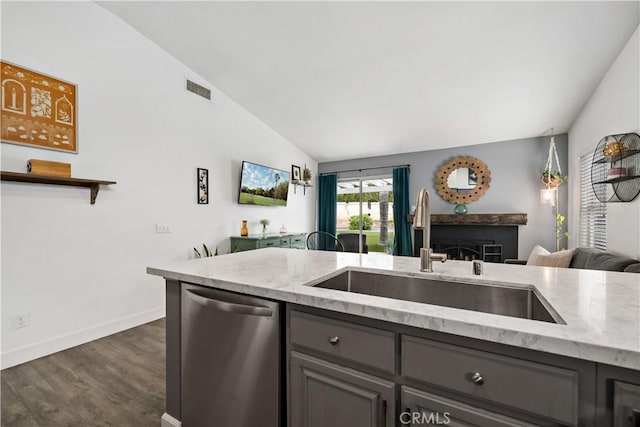 kitchen with stainless steel dishwasher, a sink, open floor plan, dark wood finished floors, and gray cabinets