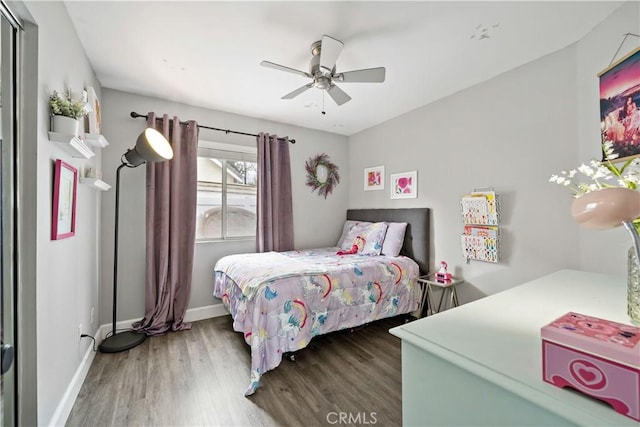 bedroom featuring wood finished floors, ceiling fan, and baseboards