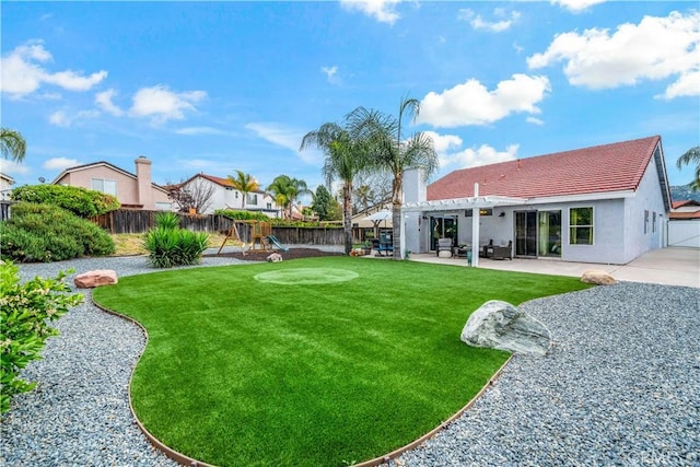 view of yard with a patio area, a fenced backyard, a playground, and a pergola