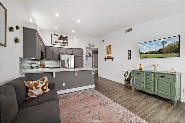 living area featuring recessed lighting, visible vents, baseboards, and dark wood-type flooring