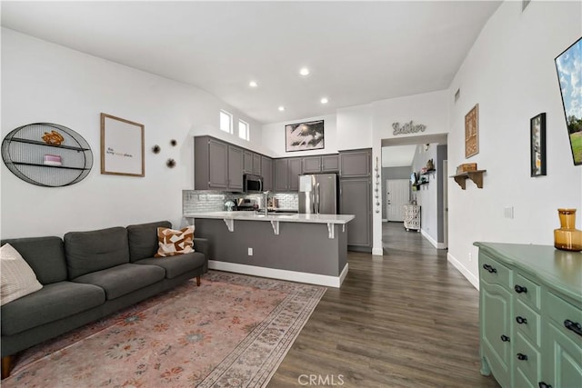 living area featuring visible vents, recessed lighting, dark wood finished floors, and baseboards