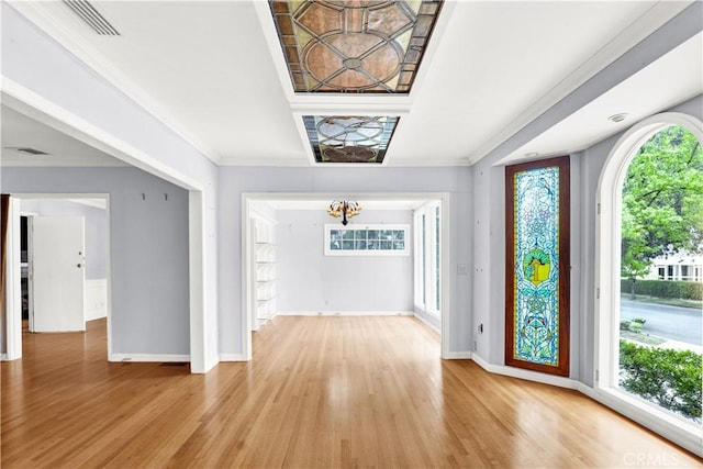 entryway with plenty of natural light, light wood finished floors, and baseboards