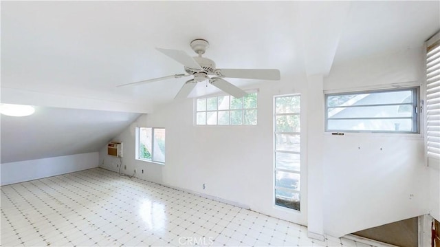 additional living space featuring light floors, a ceiling fan, and lofted ceiling