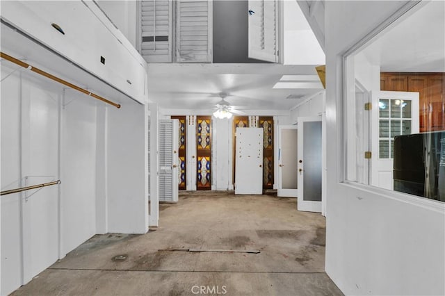 entrance foyer featuring ceiling fan and unfinished concrete flooring