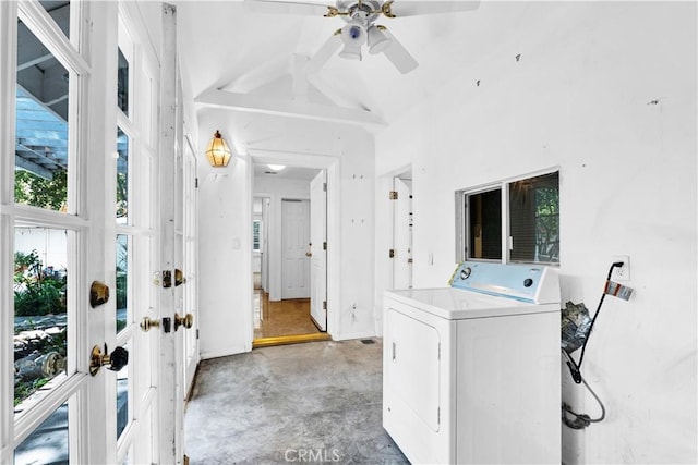 laundry area with a high ceiling, a healthy amount of sunlight, ceiling fan, and washer / clothes dryer