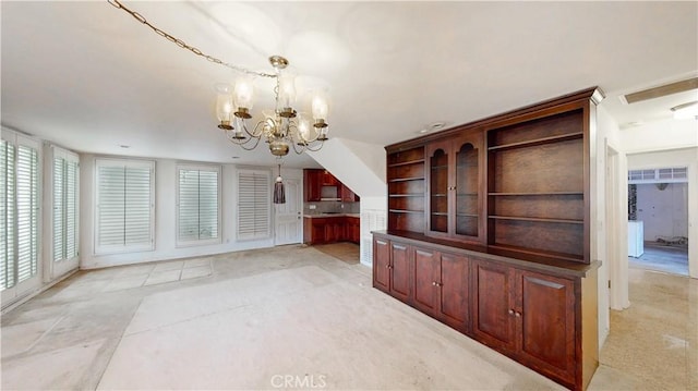 unfurnished dining area featuring visible vents and a notable chandelier