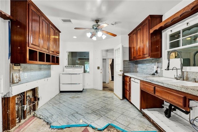kitchen with a sink, ceiling fan, backsplash, and white appliances