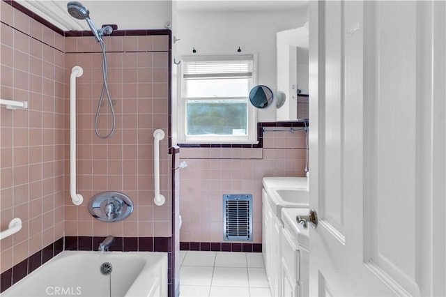 full bath with shower / tub combination, visible vents, tile walls, tile patterned floors, and vanity