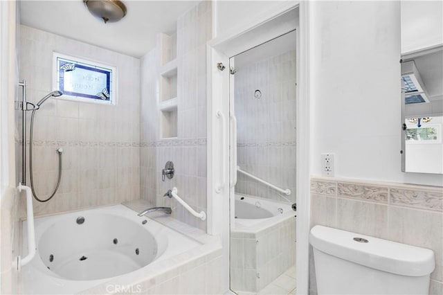 full bathroom featuring toilet, tile walls, and a combined bath / shower with jetted tub