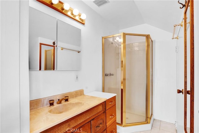 full bathroom featuring a shower stall, visible vents, vaulted ceiling, vanity, and tile patterned flooring