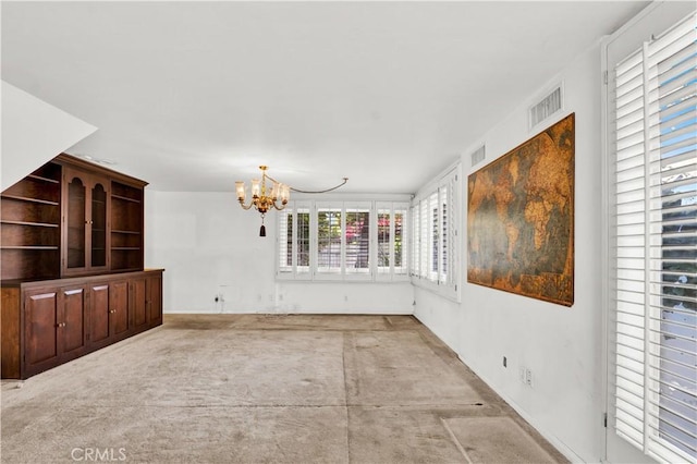 unfurnished living room featuring an inviting chandelier and visible vents
