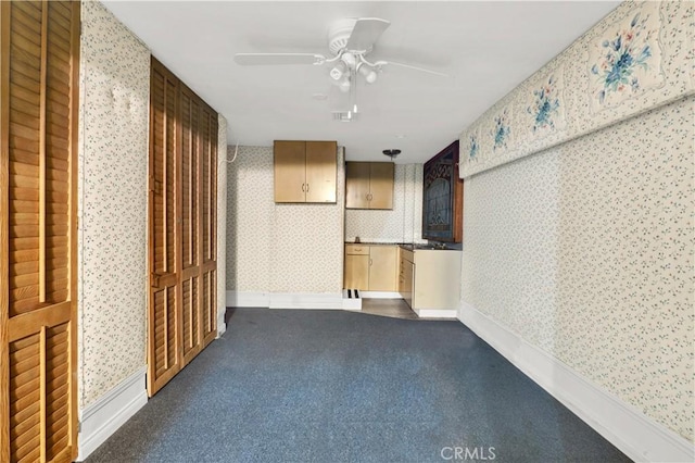 hall with dark carpet, visible vents, and wallpapered walls
