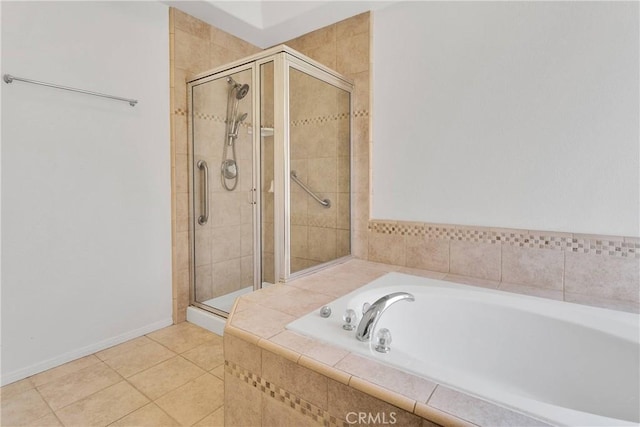 full bathroom featuring a bath, a shower stall, tile patterned floors, and baseboards