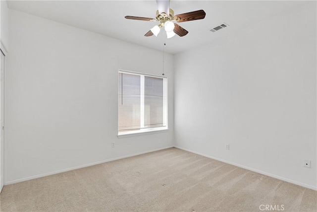 empty room featuring visible vents, ceiling fan, light carpet, and baseboards