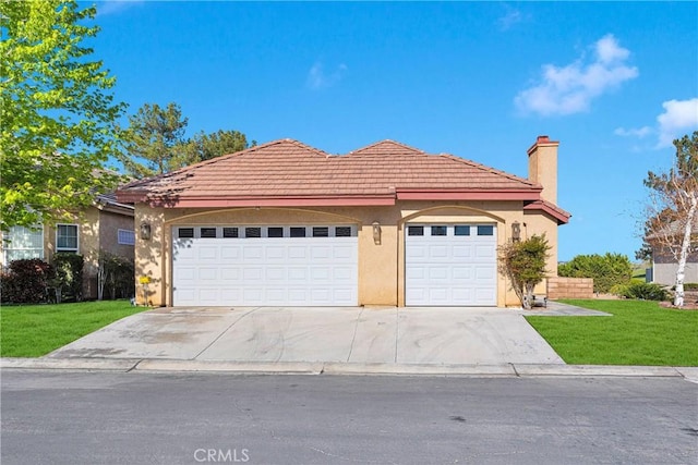 single story home with a tile roof, a front yard, a chimney, concrete driveway, and an attached garage