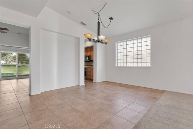 unfurnished dining area with light tile patterned floors, visible vents, and ceiling fan with notable chandelier