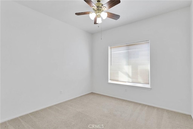 unfurnished room with ceiling fan, light carpet, and baseboards