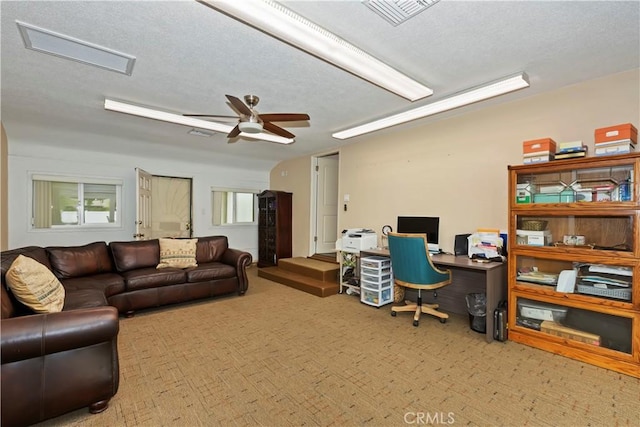 office featuring visible vents, a ceiling fan, a textured ceiling, and carpet flooring