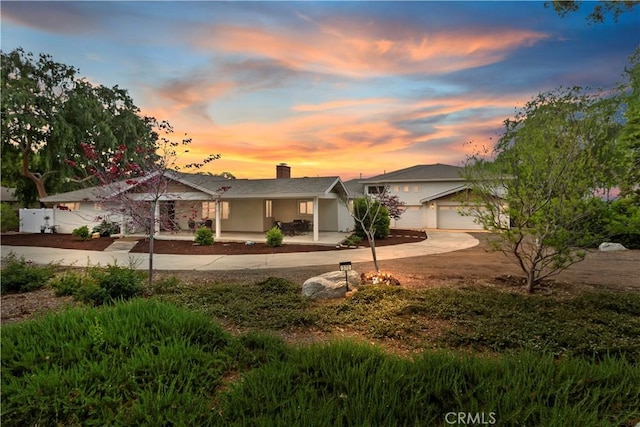 370 W 13th St, Upland, CA 91786 - ranch-style home with curved driveway, a porch, a garage, and a chimney