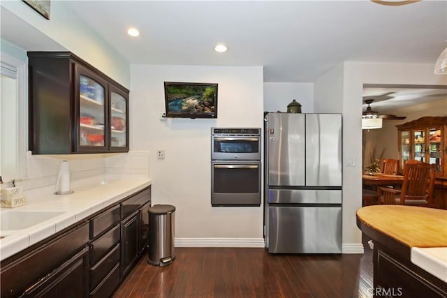 370 W 13th St, Upland, CA 91786 - kitchen featuring stainless steel appliances, glass insert cabinets, dark brown cabinets, dark wood-style flooring, and recessed lighting