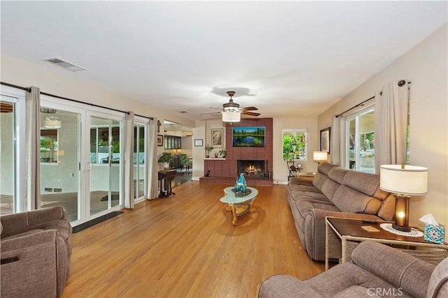 370 W 13th St, Upland, CA 91786 - living area with a ceiling fan, light wood finished floors, and a large fireplace