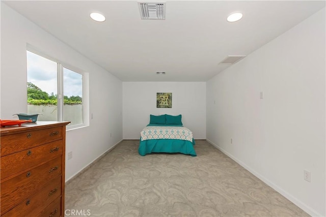 bedroom featuring recessed lighting, visible vents, light carpet, and baseboards