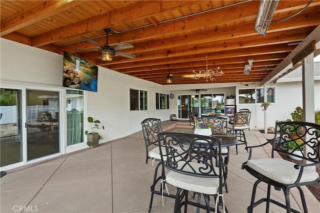 view of patio with a ceiling fan and outdoor dining area