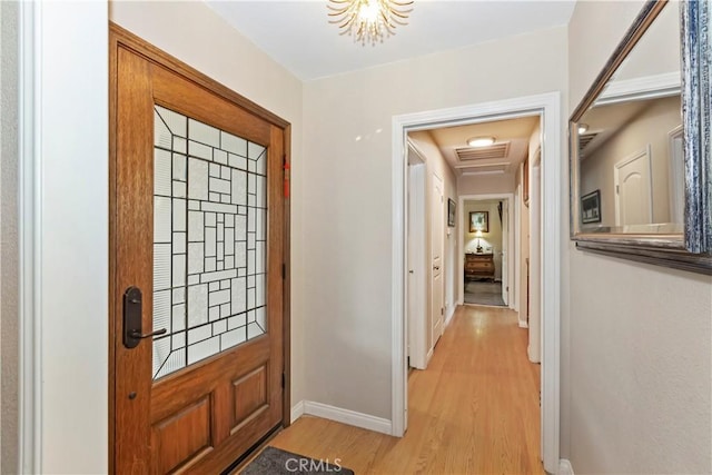 entrance foyer featuring light wood finished floors, visible vents, and baseboards