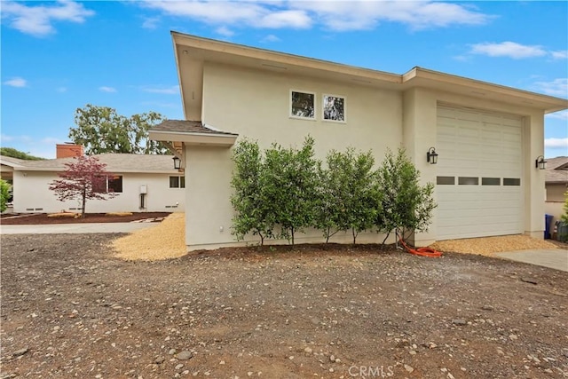 view of home's exterior featuring an attached garage and stucco siding