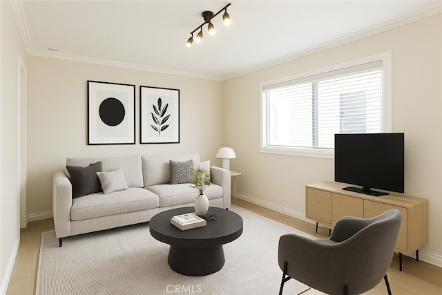 living room with ornamental molding and baseboards
