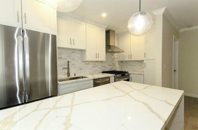 kitchen featuring a sink, tasteful backsplash, crown molding, wall chimney exhaust hood, and appliances with stainless steel finishes
