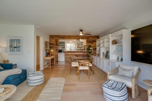 living area featuring a ceiling fan and light wood-type flooring