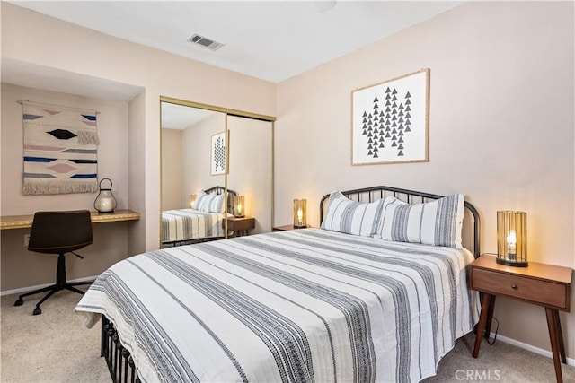 bedroom featuring baseboards, visible vents, carpet floors, and a closet