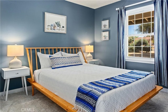 bedroom with carpet and baseboards