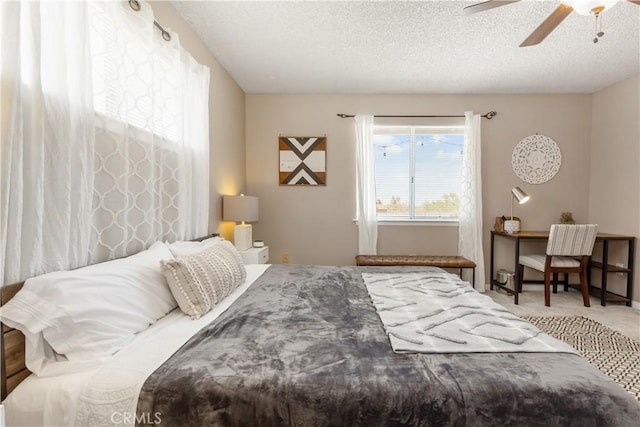 carpeted bedroom featuring a textured ceiling and a ceiling fan