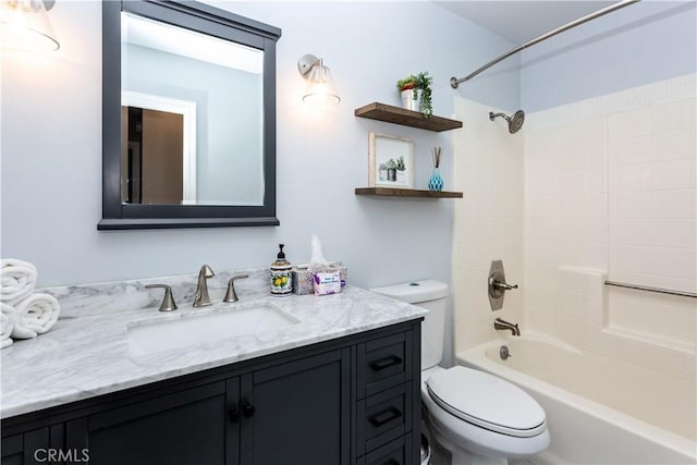 bathroom with toilet, vanity, and  shower combination
