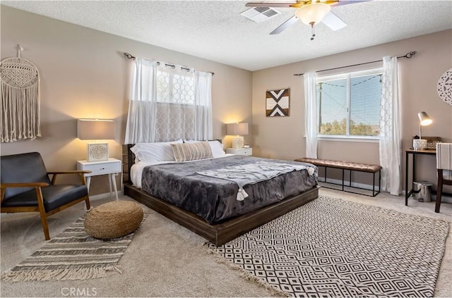 bedroom featuring visible vents, a ceiling fan, a textured ceiling, and carpet flooring