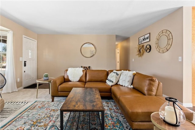 living area featuring carpet floors and baseboards