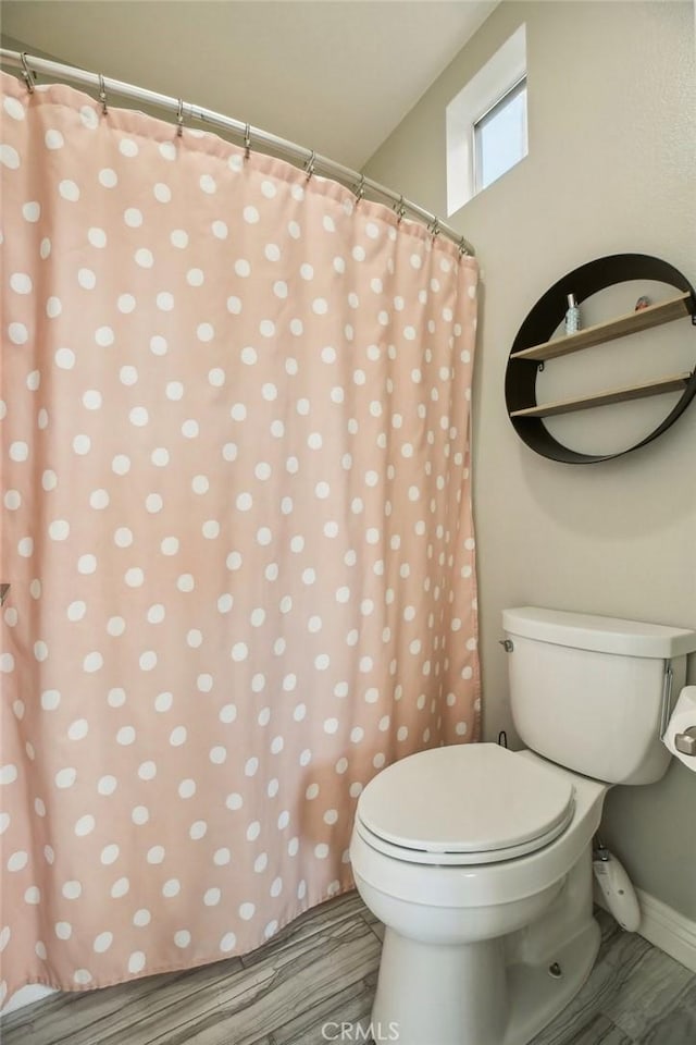 full bathroom with wood finished floors and toilet