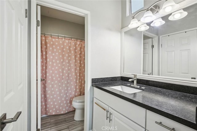 full bath featuring an inviting chandelier, vanity, curtained shower, toilet, and wood finished floors