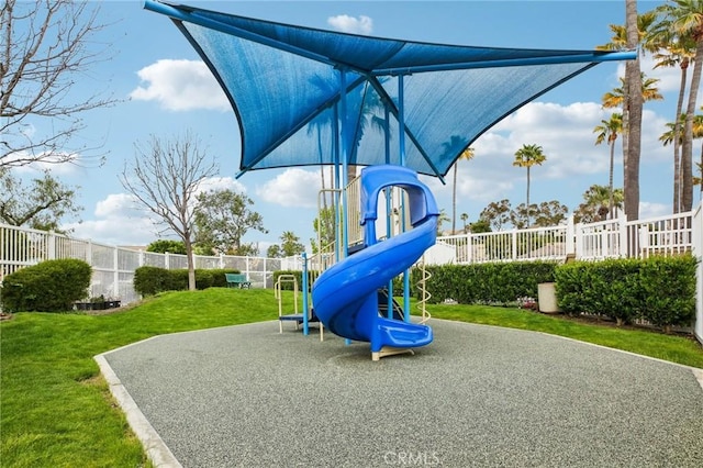 community playground with a lawn and fence