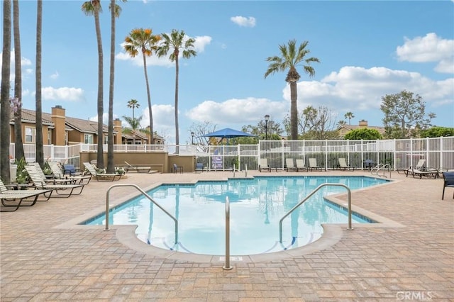 pool featuring fence and a patio