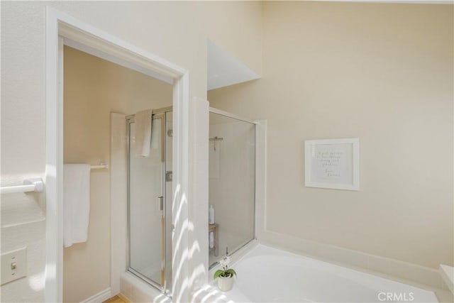 full bathroom with a garden tub and a stall shower