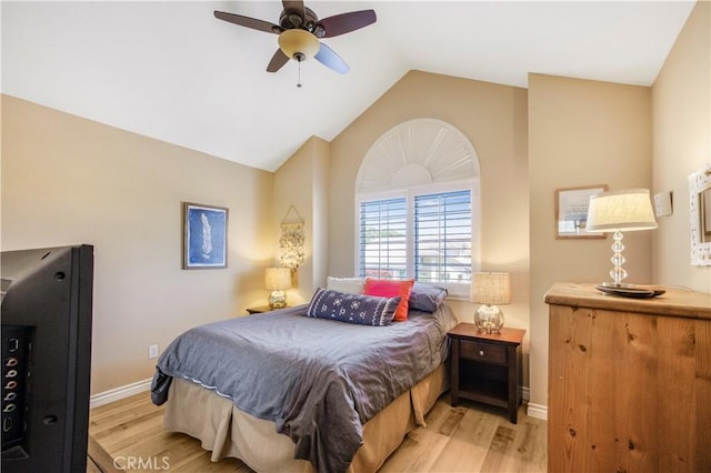 bedroom with ceiling fan, baseboards, vaulted ceiling, and light wood-style floors