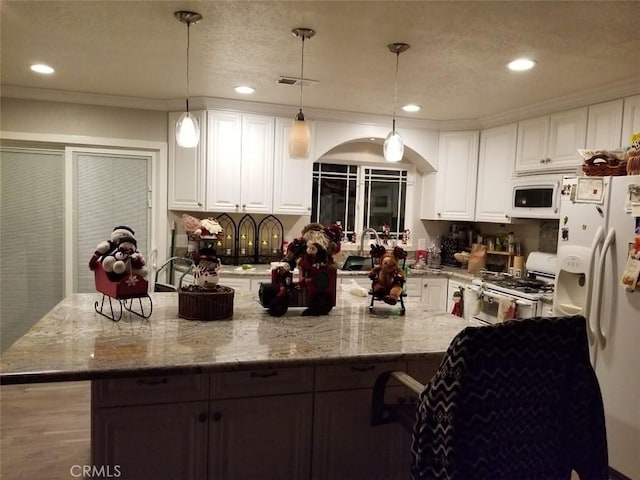 kitchen featuring visible vents, white appliances, light stone countertops, and white cabinets
