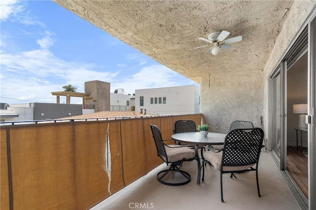 balcony with a ceiling fan and outdoor dining space